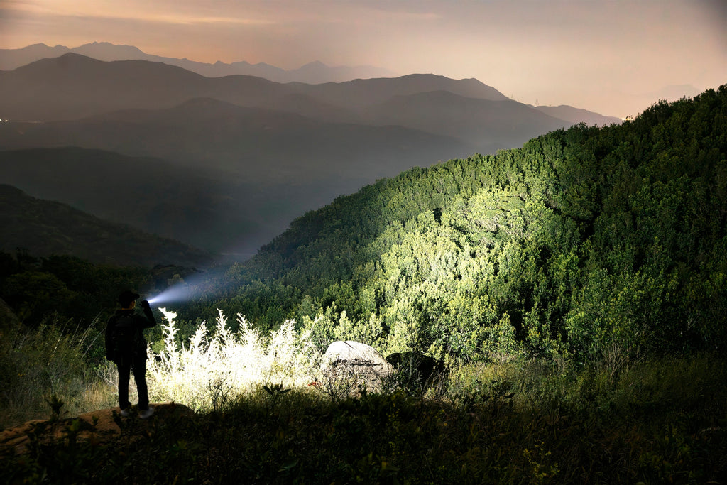 Olight Warrior Ultra illuminating a mountainside at night