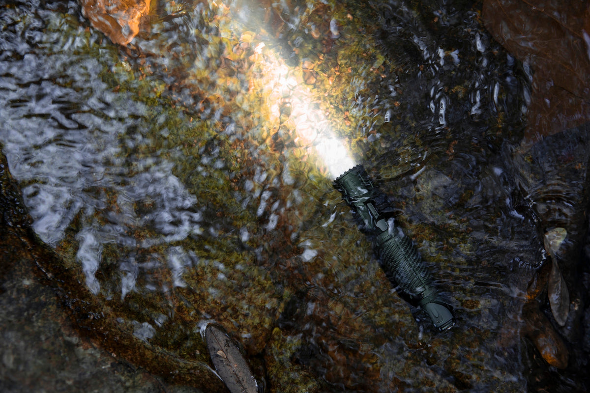 Olight Warrior Ultra operating in water to demonstrate waterproof durability