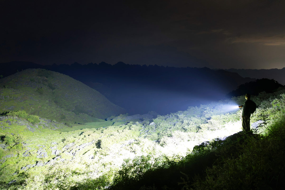 Olight Marauder 3 illuminating a wide mountain area at night