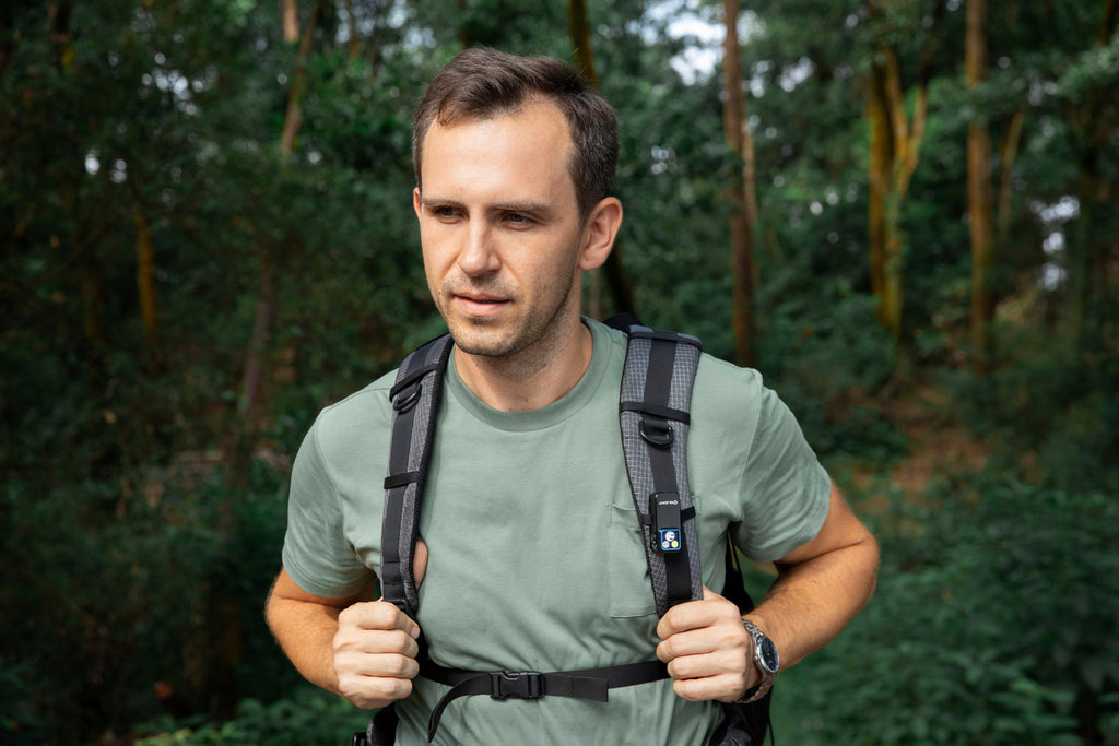 Olight Oclip 2 Pro clipped to a backpack strap outdoors