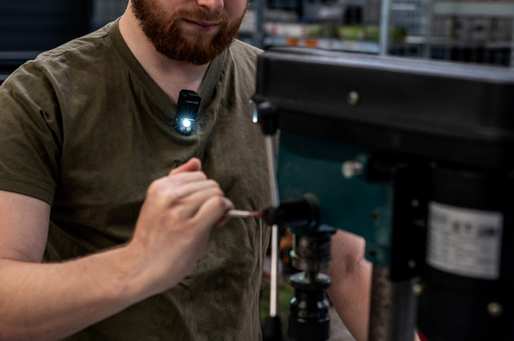 Olight Oclip 2 Pro clipped to a shirt during workshop use