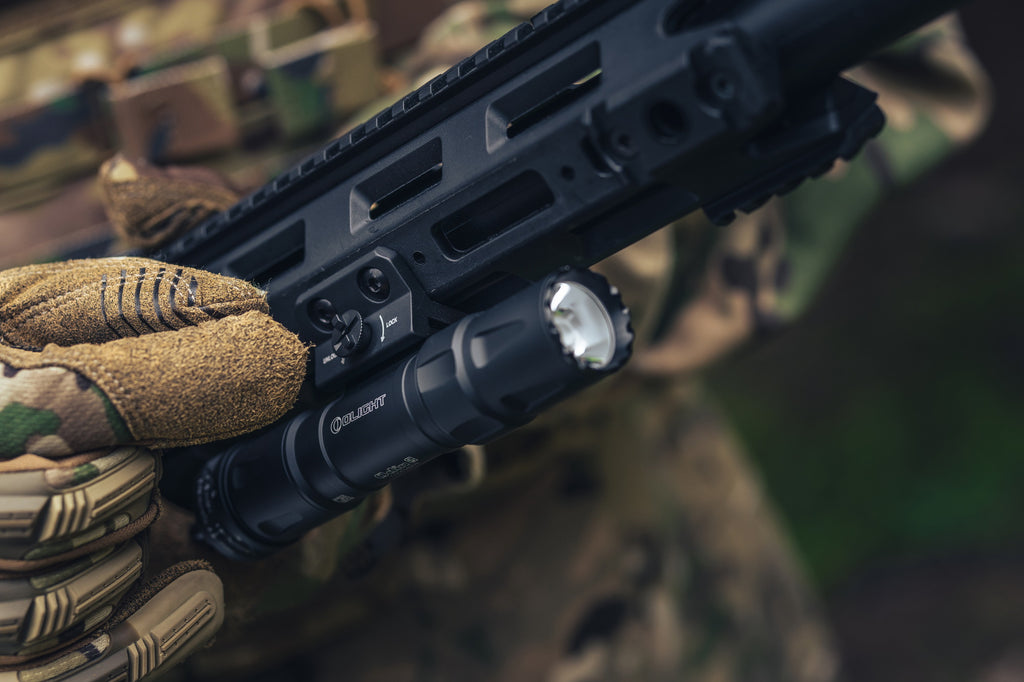 Olight Odin S mounted on a rifle in an outdoor use scene