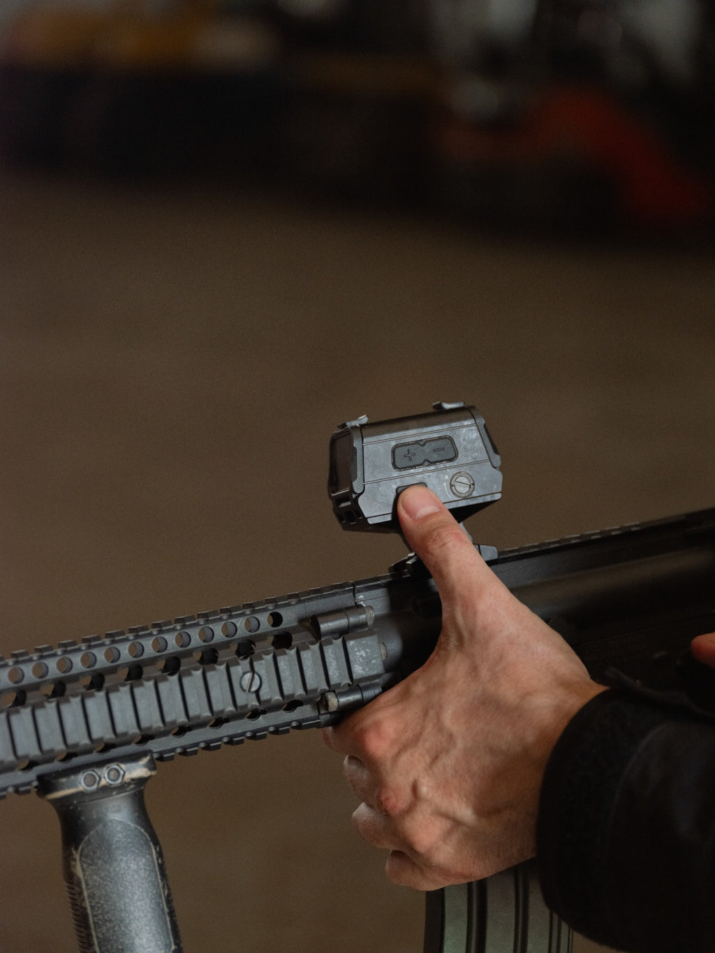 Olight OSIGHT R enclosed red dot sight mounted for outdoor use, side control view