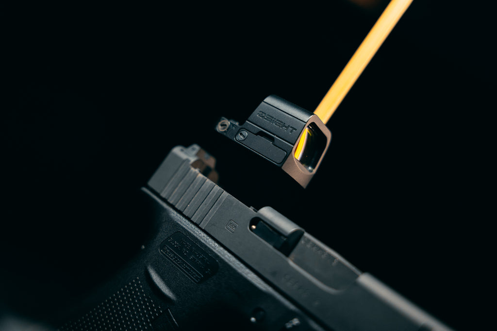 Olight OSIGHT SE red dot sight mounted on a handgun in a close-up lifestyle view